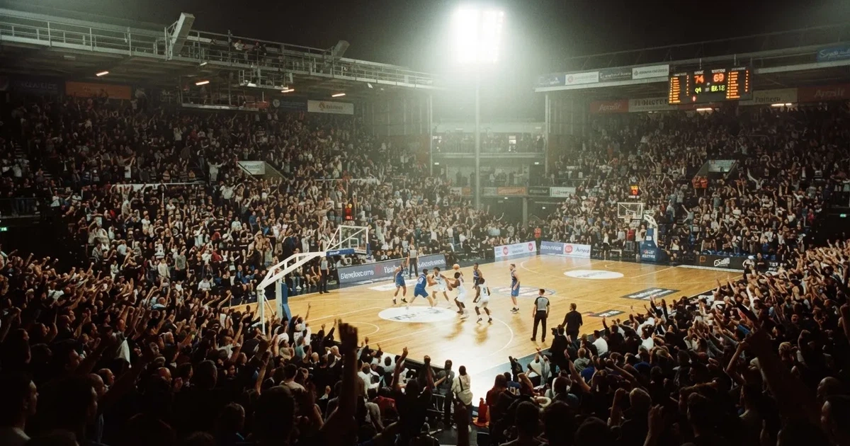 Un pabellón deportivo lleno bajo los focos, fotografiado desde muy lejos